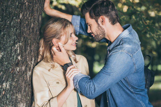 istock romantic couple looking at each other in autumn park 1048759956