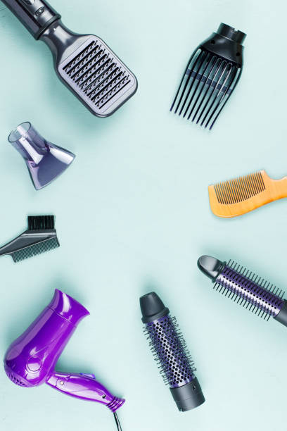 istock Hairdressing tools with flowers on blue wooden background 1048761014