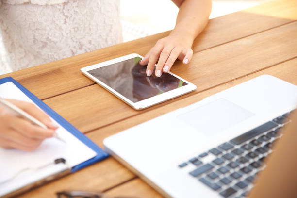 istock Woman hand writing and touching digital tablet 1048764016