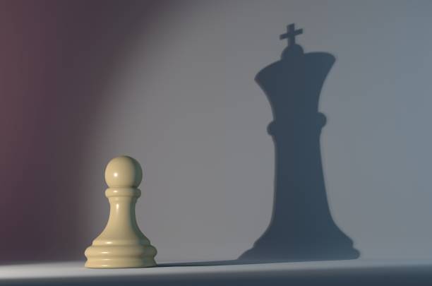 istock Pawn Chess Piece with the Shadow of a King 1048764178
