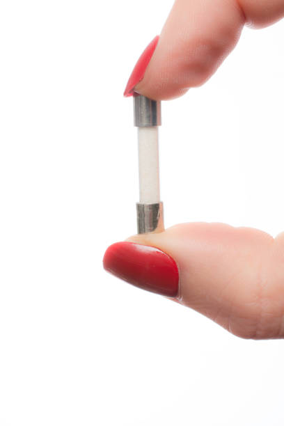istock close up Woman hand holding electrical fuse 1048767536