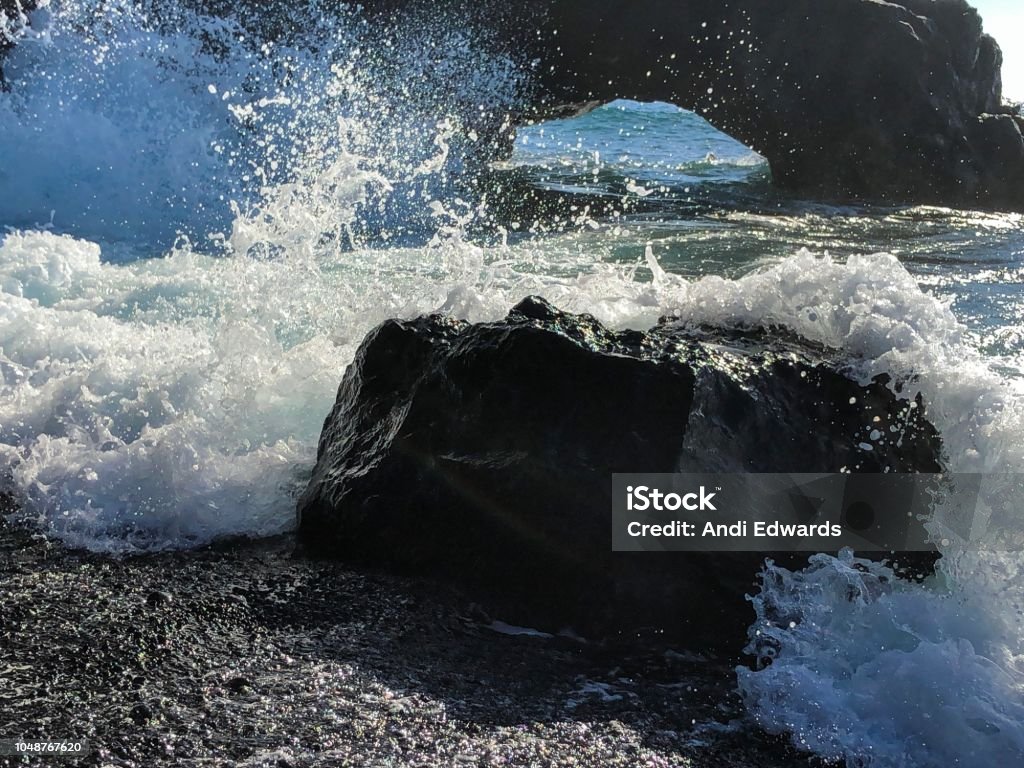Ocean waves crashing over black volcanic rock and sand, La Palma Island, Canary Islands, Spain Black sand beach Black Sand Stock Photo