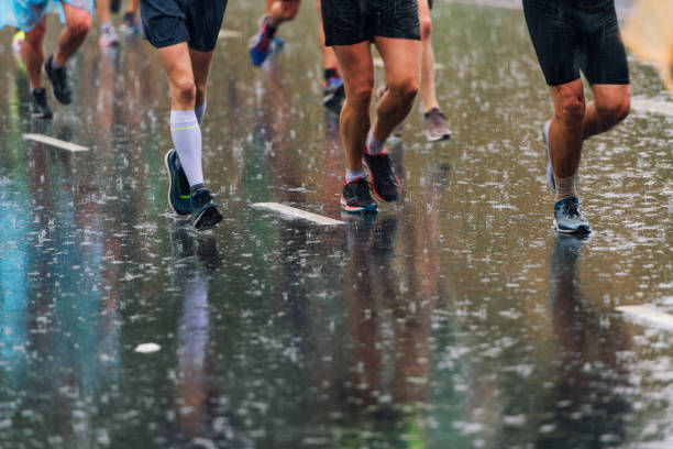 istock Marathon runners in bad weather 1048767700