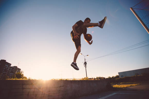 istock A jumping athlete dribbling in the air 1048768580