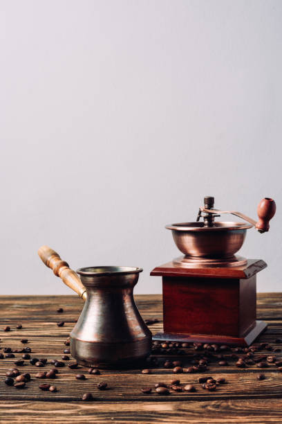istock vintage cezve and coffee grinder with coffee beans on rustic wooden table 1048770732