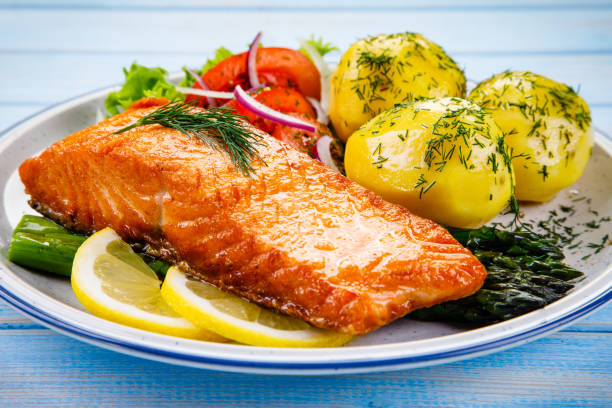 istock Grilled salmon with boiled potatoes and vegetable salad 1048771148