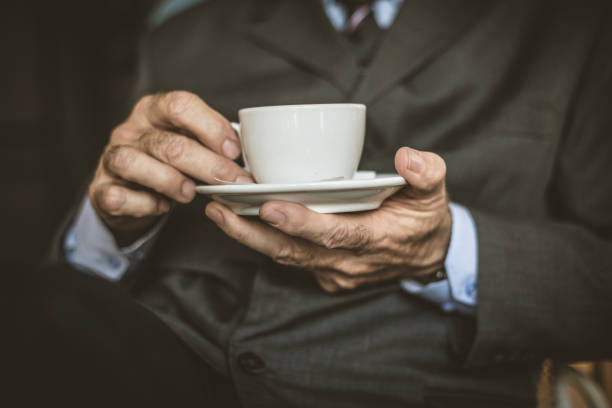 Hand holding a mug in the window frame welcoming the morning