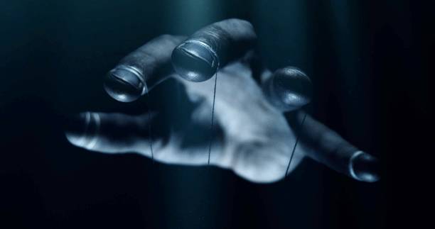istock Puppet hands from leadership controlling our lives. Concept 1048784312