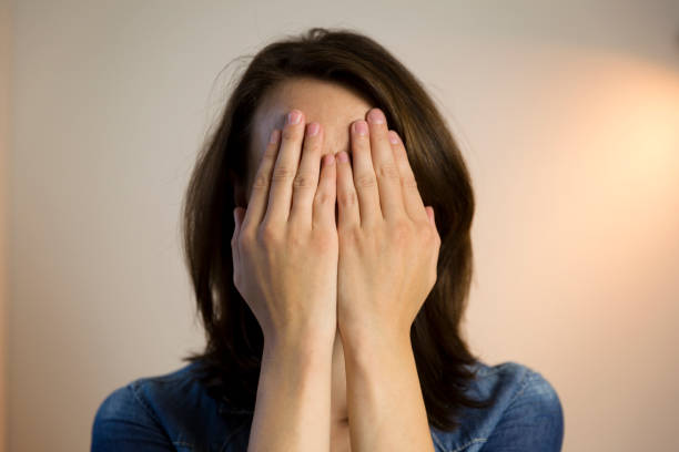istock Beautiful women hiding behind her hands. 1048784762