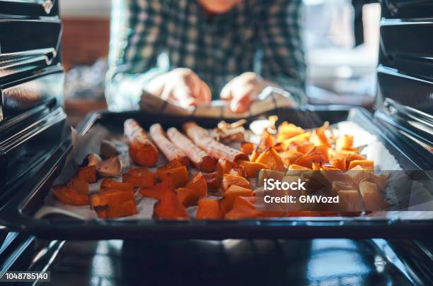 Roasting Pumpkins In The Oven Stock Photo - Download Image Now - Vegetable, Cooking, Oven