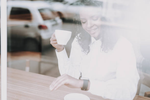 istock Smile. Girl. Sitting Alone. Cup of Tea.. 1048789676