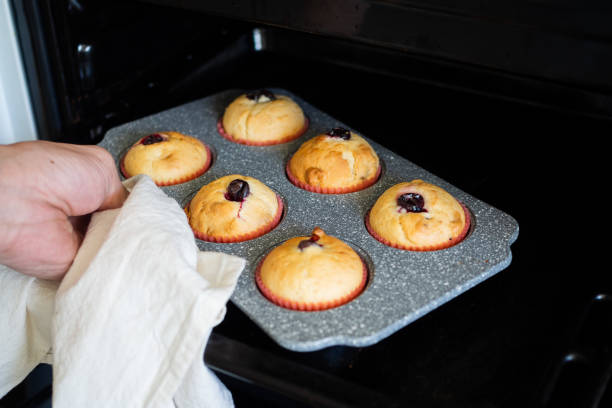 istock The baker takes out the oven muffins. 1048789702