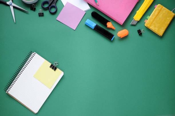 istock Study stuff. Education background. Stationery. Aspects of education. Pencil, papers, markers, scissors, folder, scotch tape, clips and notebook on the table. 1048789990