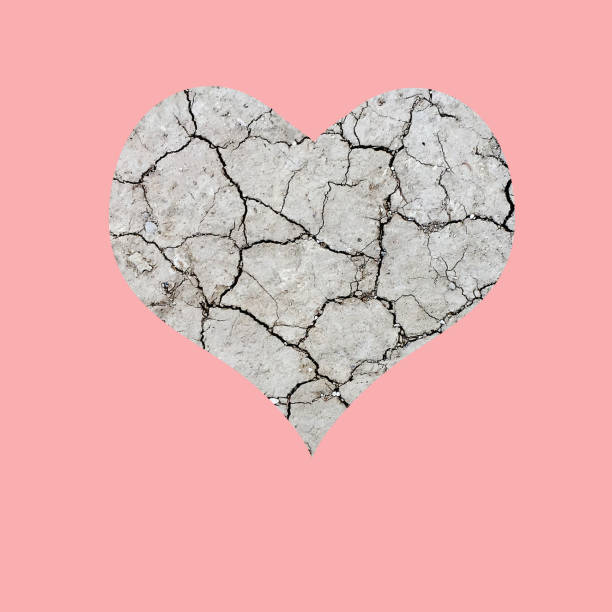 istock Dry cracked heart on pink background 1048790442