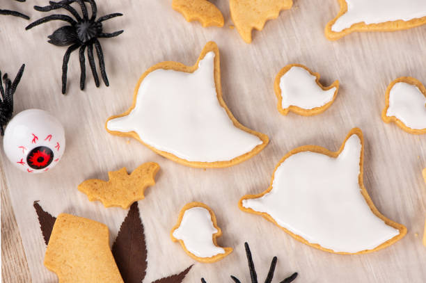 istock Fresh homemade decorating halloween cookies with ghost, creeping spider, bat, haunted castle and horrifying eyeball on wooden background, copy space 1048793420