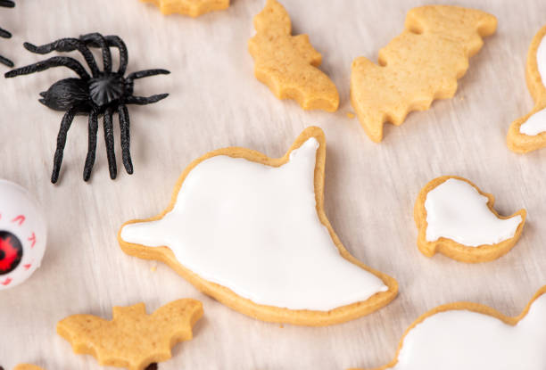 istock Fresh homemade decorating halloween cookies with ghost, creeping spider, bat, haunted castle and horrifying eyeball on wooden background, copy space 1048793520