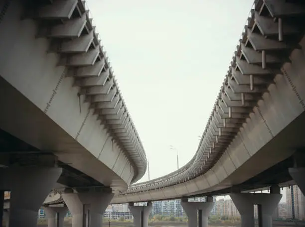 Road-bridges with columns on the background of the daytime city. Wide shot