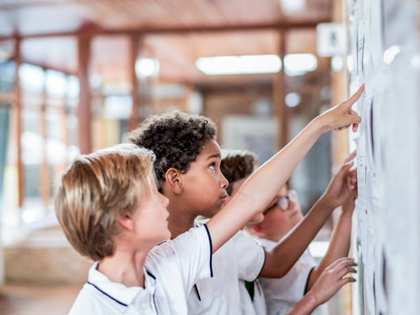istock Junior high students reading notice in school 1048803104