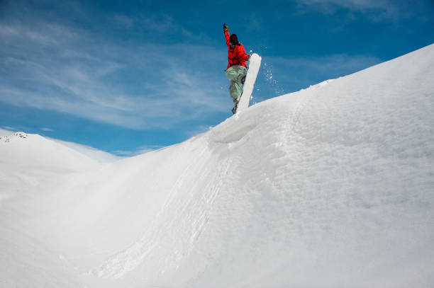 istock Jumping snowboarder keeping one hand on the snowboard 1048803848