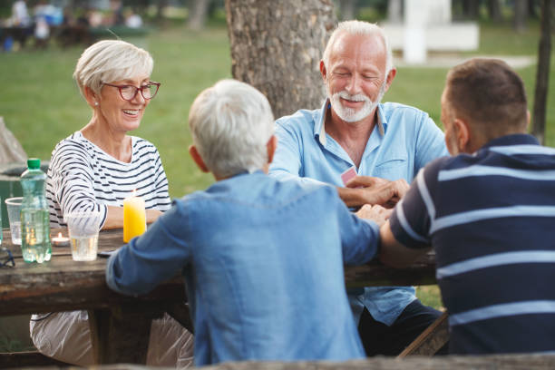 istock Senior people playing cards game 1048810488