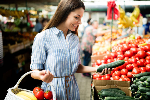 istock Young woman buying vegetables 1048814784