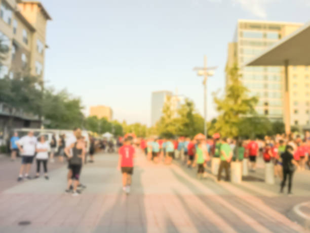 istock Blurry background multiethnic participants crowd at 5K running event in Texas, USA 1048815476