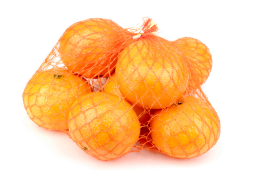 A net of satsuma oranges, isolated on white with some soft shadow.