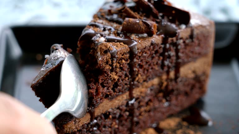 Cutting Chocolate cake close up.