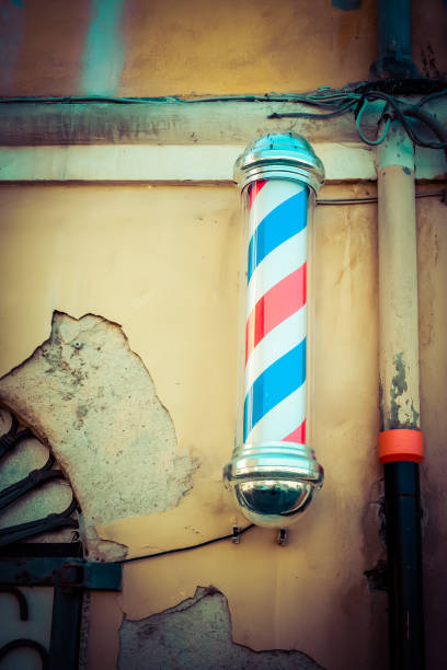 istock old barber shop with barber pole 1048818500