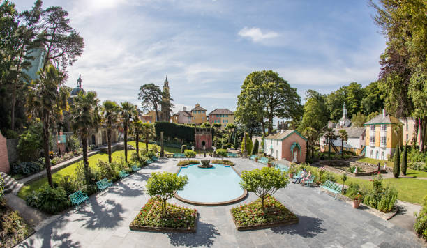 Portmeirion - June 2018 Pictures of Portmeirion Village, in Wales, a well known as the location for the 1960s cult TV series The Prisoner. It comprises a cluster of colour-washed buildings around a central piazza, scenic surroundings and extensive woodlands, two hotels, historic cottages, gift shops, spa & award winning restaurants. portmeirion stock pictures, royalty-free photos & images