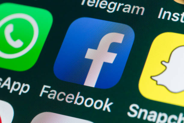 London, UK - July 31, 2018: The buttons of Facebook, Snapchat, WhatsApp, Telegram and other apps on the screen of an iPhone.