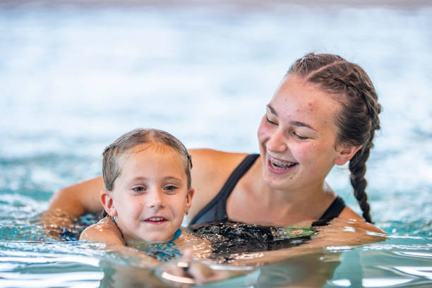 istock Girl With Swimming Teacher 1048821236