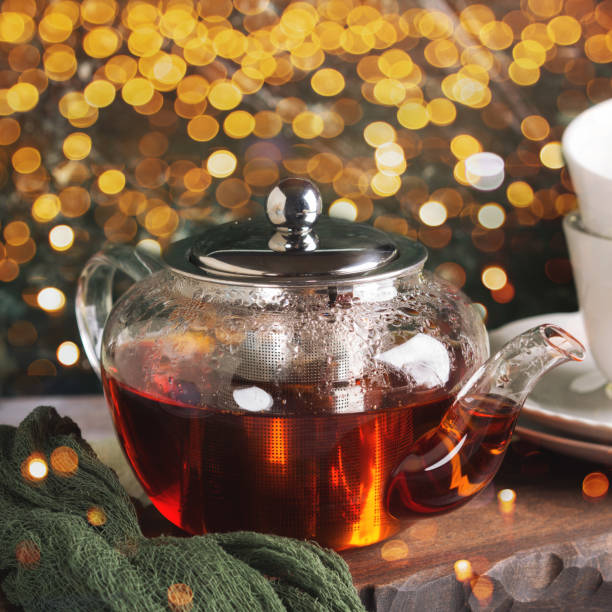 istock Hot tea in glass tea pot over green background 1048825280