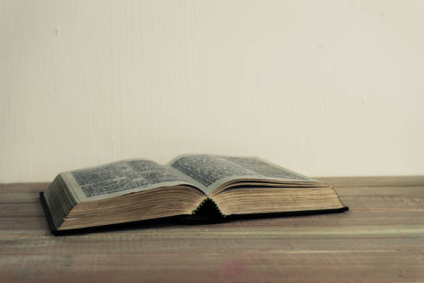 istock Bible and a crucifix on a black glass table. Beautiful background.Religion concept. 1048827896