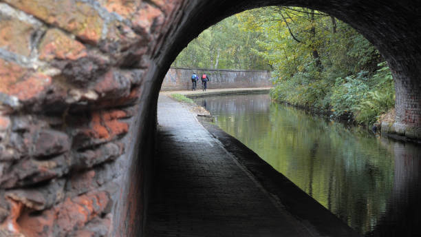 Towpath tunnel cyclists. stock photo