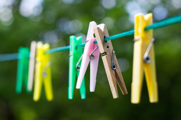 istock Colored plastic and wooden clothes pegs on the clothesline. 1048828678