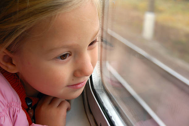 istock Little girl looking through the train window 104882994