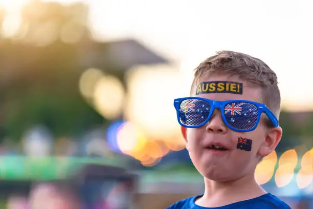 Photo of Cute Australian boy with flag tattoo on his face