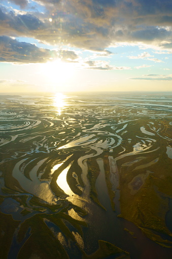 Afluentes del río Amur. Vista desde la ventana del avión. Puesta de sol photo