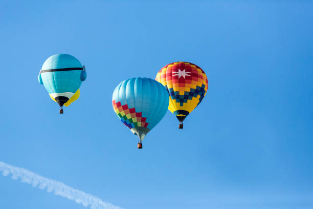 istock Hot air balloons flying in a beautiful blue clear sky 1048834158