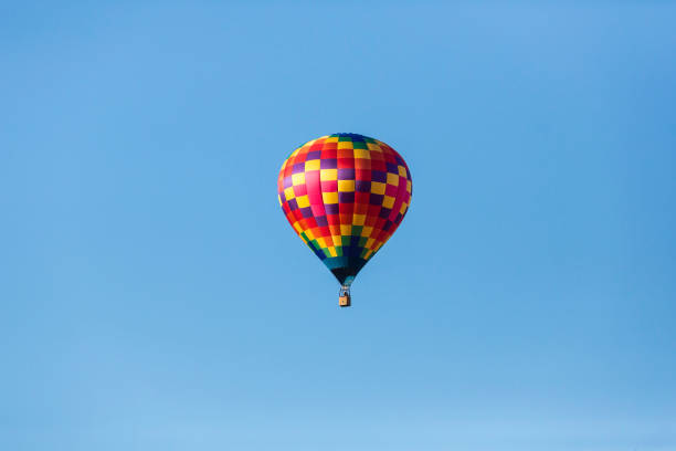 istock Hot air balloons flying in a beautiful blue clear sky 1048834200