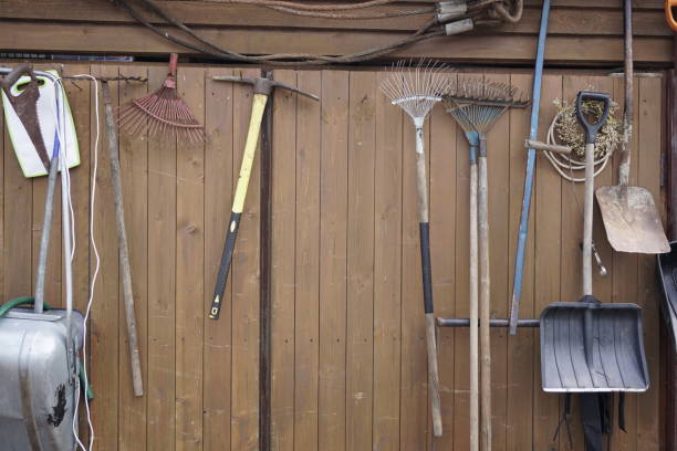 istock shovels rakes hammers hanging on wooden wall 1048834216