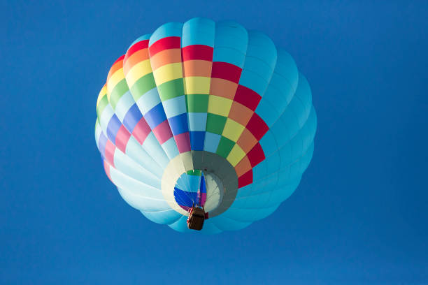 istock Hot air balloons flying in a beautiful blue clear sky 1048834270