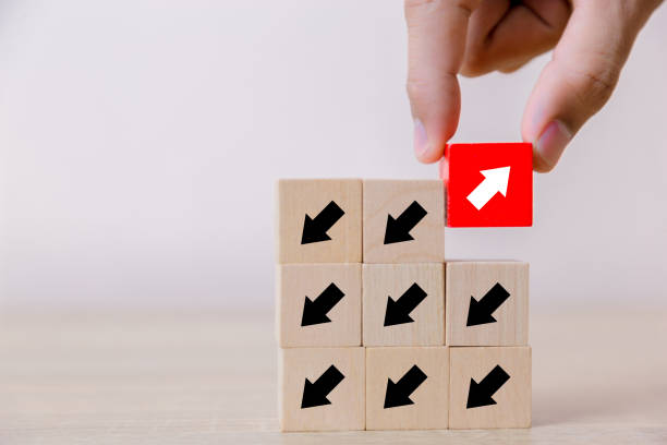 istock Red wooden blocks with white arrows facing opposite to the white arrows. With different concepts to other people. Going for success. 1048835486