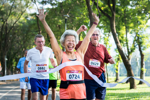 istock Happy senior running through the finish line 1048835578