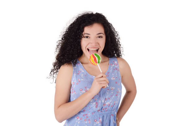 istock Latin woman eating lollipop. 1048835920
