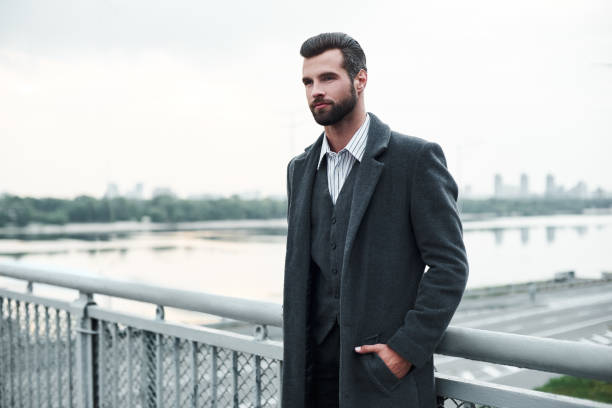 istock Confidence. Businessman standing on the bridge looking aside pensive 1048838668