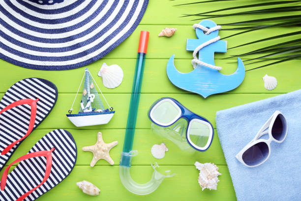 istock Beach accessories with seashells and diving mask on wooden table 1048842488