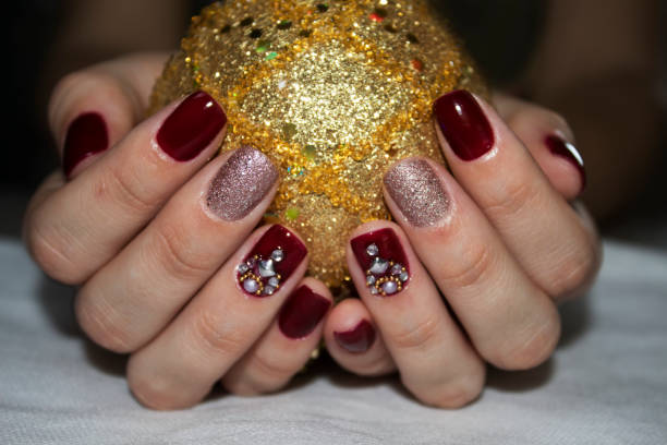 istock Female hands holding a gold Christmas ball 1048842684