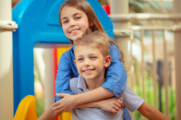 istock Cute siblings having fun together on playground 1048843000